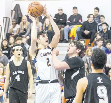  ?? BOB TYMCZYSZYN/STANDARD STAFF ?? Welland Centennial Cougars Nick Yioldassis (2) makes a shot as they host Lakeshore Catholic Gators on the first day of the Tribune Boys Basketball Tournament Wednesday.