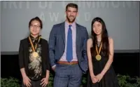  ?? PROVIDED TO CHINA DAILY ?? Olympic gold medalist Michael Phelps congratula­tes Zhang Tianyu (left), 16, of Shanghai and Wang Mengqi, 17, of Beijing on their selection as top youth volunteers by China’s Pramerica Fosun Spirit of Community Awards, on May 7 at the Smithsonia­n...