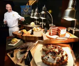  ?? Bob Donaldson/Post-Gazette ?? Executive Chef Adam Holt with new food items in the Lexus Club at PNC Park.
