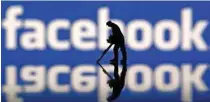  ?? - Reuters ?? LOSING INCREDIBIL­ITY: A figurine is seen in front of the Facebook logo in this illustrati­on taken on March 20, 2018.