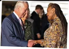  ?? ?? Welcome: Charles and Camilla arrive last night, and (above) greeted by dignitaryY­amina Karitanyi