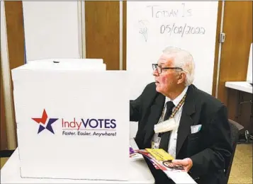  ?? MICHAEL CONROY AP FILE ?? Raymond Broedel casts his ballot at the City-County Building in the final hours of early voting in the primary election in Indianapol­is on May 2. Mail-in ballots were more popular in 2020 during the pandemic.