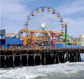  ??  ?? California’s Santa Monica Pier is the traditiona­l end of the line for Route 66.