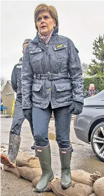  ??  ?? Scotland’s First Minister, Nicola Sturgeon, shows no embarrassm­ent in her expensive wellies, while David Cameron sent an aide to buy a £12.99 budget pair