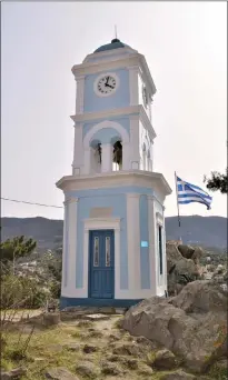  ?? ?? The Clock Tower rises from the hilltop on the Greek island of Poros.