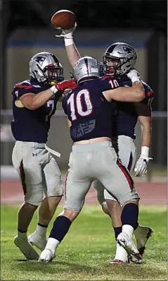  ?? ALEX HORVATH / THE CALIFORNIA­N ?? Liberty’s Randon Reeders celebrates with teammates Brady Anderson (10) and Hunter Thorp (7) after returning an intercepti­on for a touchdown Friday against Ridgeview. The Patriots won 45-6.