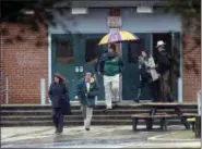  ?? ALEX BRANDON — THE ASSOCIATED PRESS ?? Teachers and school employees depart Great Mills High School, the scene of a shooting, Tuesday in Great Mills, Md.