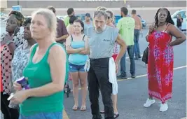  ?? JOE RAEDLE/GETTY ?? Billy Joe Patterson stands in line to receive food from the Salvation Army in Panama City.