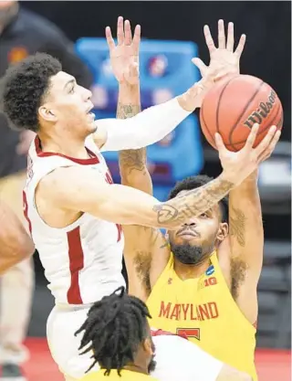  ?? MARK HUMPHREY/AP ?? Alabama’s Jahvon Quinerly scores over Maryland’s Eric Ayala during the first half of an NCAA tournament second-round game at Bankers Life Fieldhouse in Indianapol­is on Monday night.