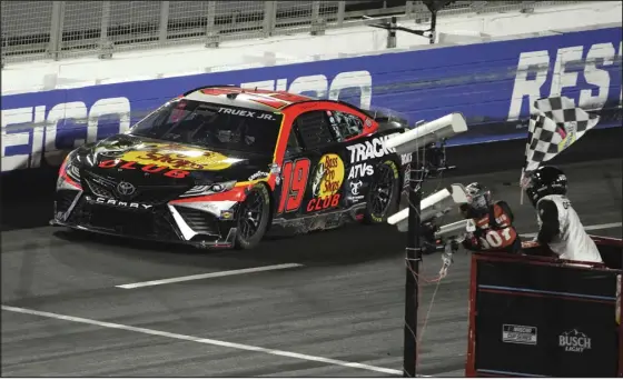  ?? MARK J. TERRILL — THE ASSOCIATED PRESS ?? NASCAR driver Martin Truex Jr. wins the Busch Light Clash NASCAR exhibition auto race at Los Angeles Memorial Coliseum on Sunday.