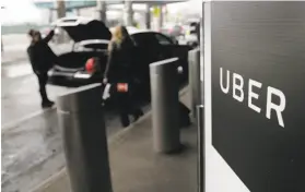  ?? Seth Wenig / Associated Press ?? A sign marks a pickup point for the Uber car service at LaGuardia Airport in New York. Uber resumed testing autonomous vehicles on Thursday.