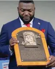  ?? The Associated Press ?? ■ Hall of Fame inductee David Ortiz, formerly of the Boston Red Sox, holds his plaque during the National Baseball Hall of Fame induction ceremony Sunday at the Clark Sports Center in Cooperstow­n, N.Y.