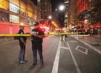  ?? JOHN HANLEY/FOR THE TORONTO STAR ?? Police tape off the downtown restaurant where Simon Giannini, a real estate agent, was killed. His death and that of Everone Paul Mitchell, killed on the same day in Regent Park, received very different treatment.