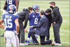  ?? Jamie Sabau / Getty Images ?? Trainers tend to Daniel Jones (8) of the Giants after he was injured during the second half against the Bengals.