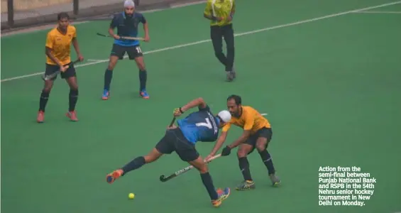  ??  ?? Action from the semi- final between Punjab National Bank and RSPB in the 54th Nehru senior hockey tournament in New Delhi on Monday.