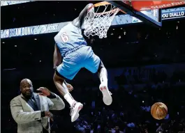  ?? ASSOCIATED PRESS ?? OKLAHOMA CITY THUNDER Hamidou Diallo leaps over former NBA player Shaquille O’Neal during the NBA All-Star Slam Dunk contest Saturday in Charlotte, N.C. Diallo won the contest.