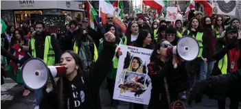  ?? — AFP photo ?? Protesters call on the United Nations to take action against the treatment of women in Iran, following the death of Mahsa Amini while in the custody of the morality police, during a demonstrat­ion in New York City.