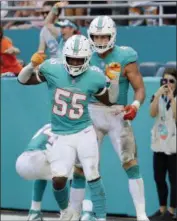  ?? LYNNE SLADKY - THE ASSOCIATED PRESS ?? Miami Dolphins outside linebacker Jerome Baker (55) celebrates a touchdown, during the second half of an NFL football game against the New York Jets, Sunday, Nov. 4, 2018, in Miami Gardens, Fla.