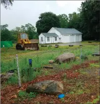 ?? Photos by Joseph B. Nadeau ?? The town will soon clear away the house and outlying garage on the Diamond Hill Road property where a new police station will be constructe­d.