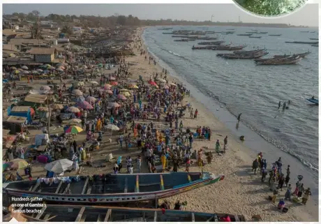  ??  ?? Hundreds gather on one of Gambia’s famous beaches