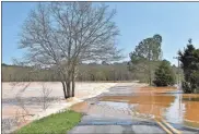  ?? Blake Silvers ?? Love Bridge Road in Gordon County remained closed Friday with fast flowing water over the roadway.