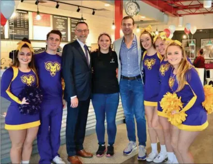  ?? FRAN MAYE - DIGITAL FIRST MEDIA ?? West Chester University cheerleade­rs were among those who helped a student-run coffee shop, Saxbys, to collect funds for West Chester’s Melton Center during Giving Tuesday.