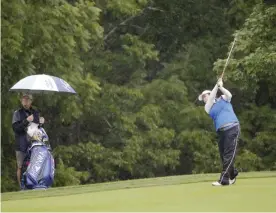  ??  ?? BEDMINSTER: China’s Shanshan Feng hits an approach shot on the second fairway during the second round of the US Women’s Open Golf tournament Friday, in Bedminster. — AP