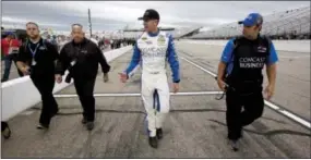  ?? JIM COLE — THE ASSOCIATED PRESS ?? Carl Edwards acknowledg­es fans as he walks through the pits after winning the pole Friday at New Hampshire Motor Speedway.
