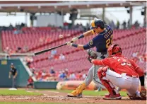  ?? AARON DOSTER/ASSOCIATED PRESS ?? The Milwaukee Brewers’ Christian Yelich bats during Wednesday’s game against the Reds in Cincinnati. The Reds won 14-11.