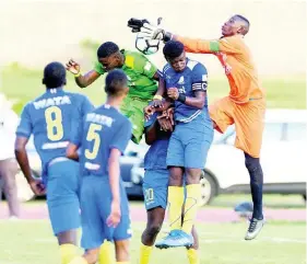  ?? FILE PHOTOS ?? Goalkeeper Shaquan Davis (right), of Hydel High, leaps into action to save a header in the ISSA/Digicel Walker Cup final against Excelsior High at Stadium East in Kingston on Wednesday, November 14, 2018.