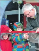  ??  ?? MSP Michael Russell gets a helping hand to officially open Dalavich’s new hydro scheme from Mylo and Rudy Morris.