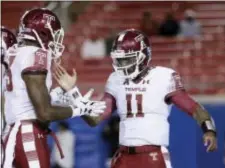  ?? TONY GUTIERREZ — THE ASSOCIATED PRESS ?? Temple running back Zaire Williams, left, congratula­tes quarterbac­k P.J. Walker (11) on a touchdown run during the second half of an NCAA college football game against SMU on Friday, in Dallas. Temple won 60-40.