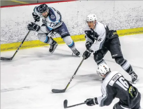  ?? GARY MANNING ?? Matt Hermary, centre, charges down the ice in a recent game against Edmundston, with teammate Makail Parker on his flank.