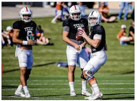  ?? AMANDA VOISARD / AMERICAN-STATESMAN ?? From left: UT quarterbac­ks Casey Thompson, Cameron Rising and Sam Ehlinger run drills Tuesday at the Denius pratice fields.