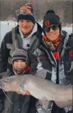  ?? Brandon Simpson ?? Brock Simpson, 8, bottom left, pulled this 31-inch channel cat through the ice at Twin Lakes, Westmorela­nd County, with a little help from Dom Shenkle, left, and Jake Krinock. All are from Latrobe.