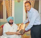  ?? HT PHOTO ?? Reliance ADAG head Anil Ambani presenting a book to Punjab chief minister Capt Amarinder Singh during their meeting in Mumbai on Tuesday.