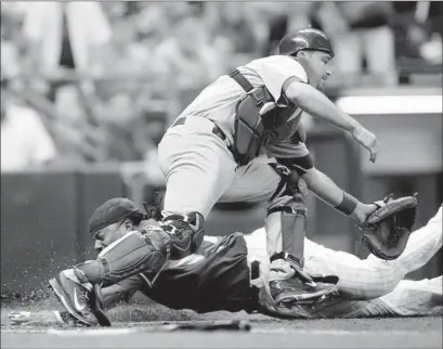  ?? Darren Hauck Associated Press ?? RICKIE WEEKS SCORES the tying run on a squeeze in the seventh inning, getting around Dodgers catcher Drew Butera.