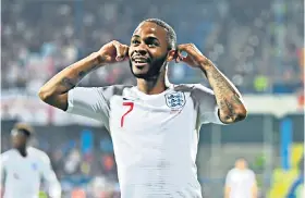  ??  ?? Perfect riposte: England forward Raheem Sterling celebrates his goal against Montenegro by gesturing to the home crowd