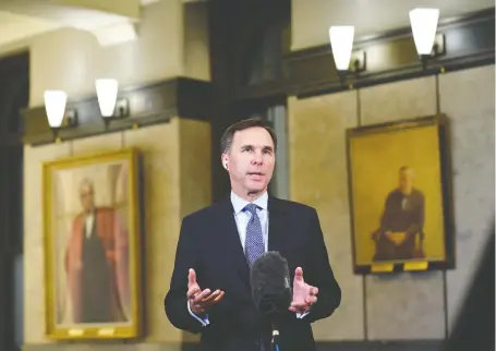  ?? JUSTIN TANG/THE CANADIAN PRESS ?? Finance Minister Bill Morneau does a remote TV interview in Ottawa on Wednesday. He says he would like to issue more longer-term debt, but he might have to work harder to get the desired yield by committing to rein in the budget, says Kevin Carmichael.