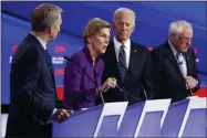  ?? PATRICK SEMANSKY ?? Democratic presidenti­al candidate Sen. Elizabeth Warren, D-Mass., second from left, speaks as fellow candidates businessma­n Tom Steyer, left, former Vice President Joe Biden and Sen. Bernie Sanders, I-Vt., right, listen, Tuesday, Jan. 14, 2020, during a Democratic presidenti­al primary debate hosted by CNN and the Des Moines Register in Des Moines, Iowa.