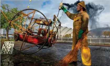  ?? Photograph: EPA ?? A protest in Glasgow against ‘highly destructiv­e dredging or bottom-trawling equipment – which Greenpeace likens to “bulldozing” the seabed’.