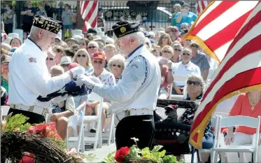  ?? NWA Democrat-Gazette/DAVID GOTTSCHALK ?? Stuart Reeves (left) and Jim Gillig, both with Siloam Springs’ American Legion post, fold the flag Monday during the Memorial Day ceremony at Fayettevil­le National Cemetery. The ceremony included the traditiona­l color presentati­ons, rifle volley,...