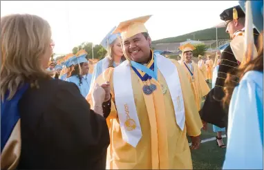  ?? RECORDER PHOTOS BY CHIEKO HARA ?? Above: Graduating seniors are congratula­ted by faculty members while walking down to the field. Below: Valedictor­ians make their speeches Thursday, June 7 at Monache High School’s 48th Commenceme­nt at Jacob Rankin Stadium in Portervill­e.