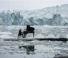  ?? PEDRO ARMESTRE/THE ASSOCIATED PRESS ?? Renowned composer Ludovico Einaudi plays his compositio­n “Elegy for the Arctic” while floating in the Arctic Ocean off the coast of Norway.