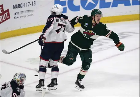  ?? ABBIE PARR — THE ASSOCIATED PRESS ?? Minnesota Wild left wing Kirill Kaprizov, right, celebrates after scoring the game-winning goal to defeat the Columbus Blue Jackets during overtime of an NHL hockey game Sunday, Feb. 26, 2023, in St. Paul, Minn.
