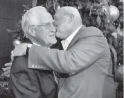  ?? JEFFREY M. BOAN AP ?? Bob Kuechenber­g gives former coach Don Shula, left, a hug and kiss on Shula’s 80th birthday party on Jan. 2, 2010.