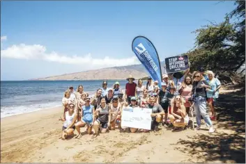  ?? Surfrider Maui Photo ?? About a dozen volunteers gathered to help pick up trash, including nearly 500 cigarette butts and over 300 plastic or foam fragments, from Sugar Beach on Saturday during the annual Hands Across the Sand global cleanup event.