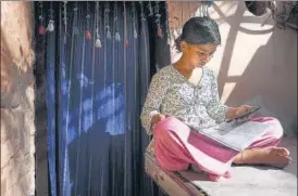  ?? SANCHIT KHANNA/HT PHOTO ?? Khushi, a Class 9 student, attends her online class using the free Wi-Fi facility provided by the Delhi government at Mayapuri.