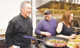  ?? AMY SHORTELL/THE MORNING CALL ?? The Stone Soup owner Chris Bavlinka watches a “Chopped”-style cooking competitio­n in his new Forks Township retail space during a grand opening March 29.