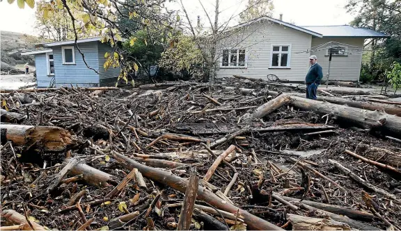  ?? MARTIN DE RUYTER/STUFF ?? A property on the Tapawera-Baton Rd after floodwater­s carrying mud and logs damaged houses and closed roads in the Wangapeka area near Tapawera in 2010.